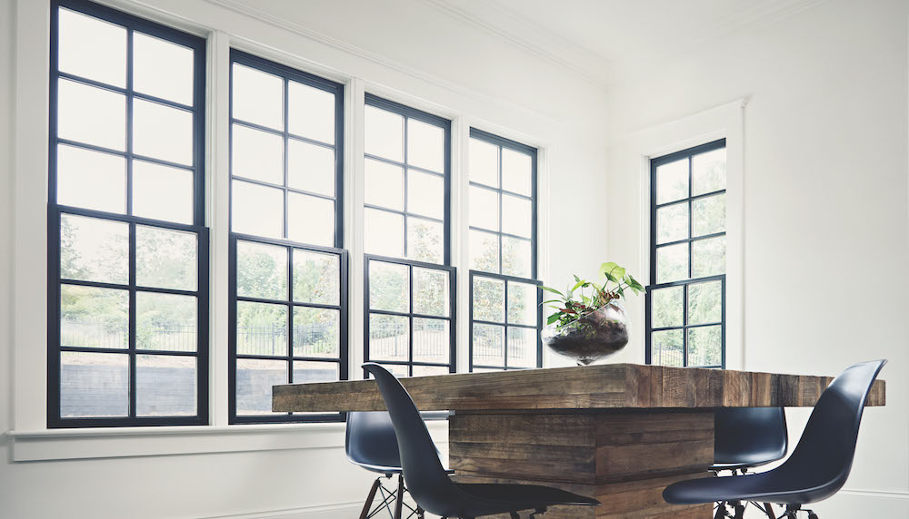 Row of W-2500™ Double-Hung Windows in black in white dining room